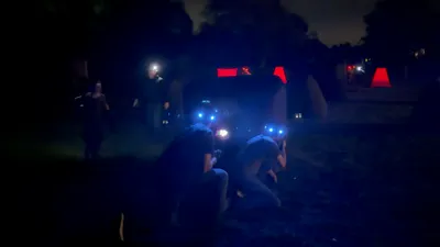 Teens playing nighttime mobile laser tag with glowing LED headbands at a 14th birthday party in Chadds Ford, PA